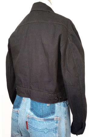 Back view of jean jacket in black twill with yoke and side tabs